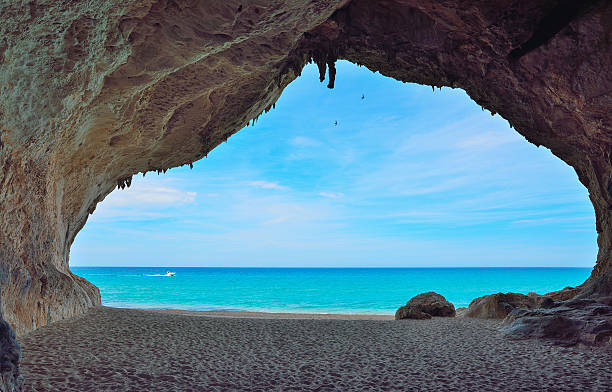 istock motorboat passing by a big cave in Cala Luna 481633278