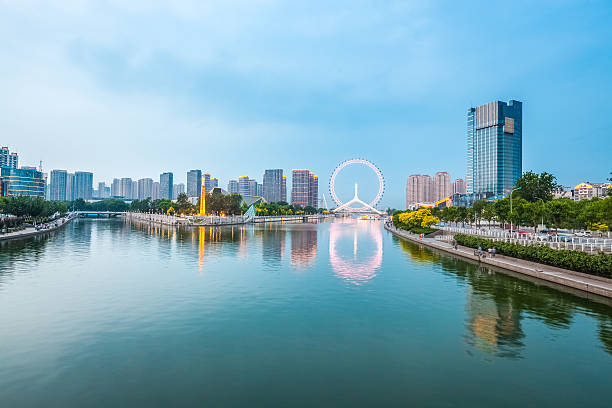 dusk scene in tianjin, ferris wheel with beautiful  river