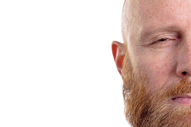 istock mad man, half face isolated on white background 481635434