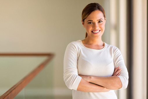 portrait of woman with arms crossed in her apartment