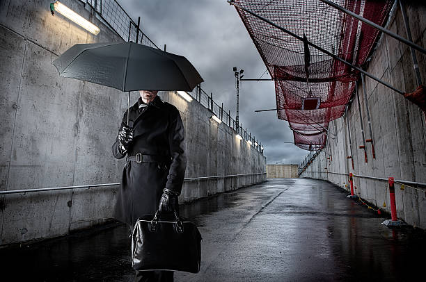 istock Businessman holding black umbrella on rainy day 481638955