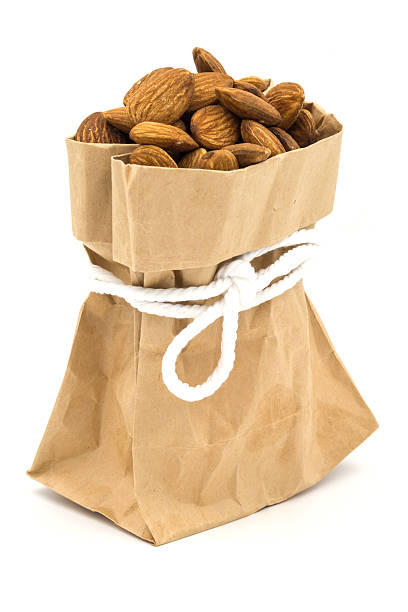 istock Almond in a brown bag on white background. 481639756