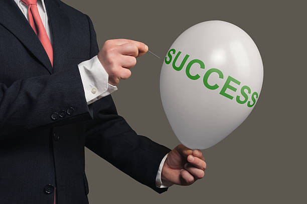 istock Man in Suit lets a Dream burst with a needle 481640248