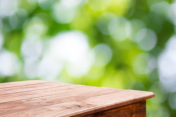 istock Green forest blurred and wooden table floor 481640578