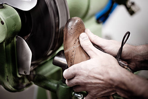 istock Shoemaker polishing sole of shoe 481641999