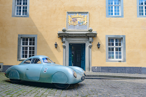 Jüchen, Germany - August 1, 2014: 1939 Porsche 64 Prototype classic sports car inside Dyck castle. The car is on display during the 2014 Classic Days event at Schloss Dyck.