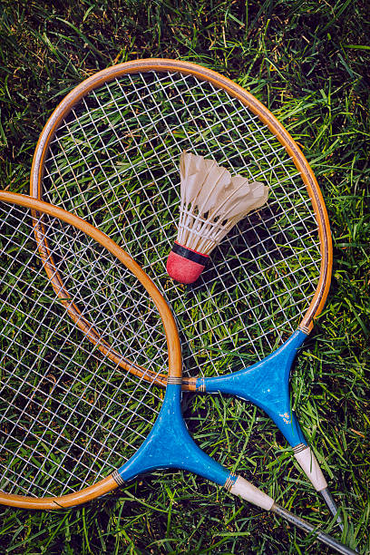 istock Vintage badminton rackets and shuttlecock lying in grass 481644008