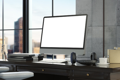 Workspace with blank computer monitor