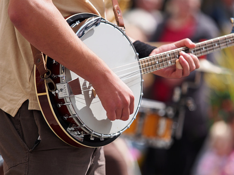 Man playing a banjo during a street performance