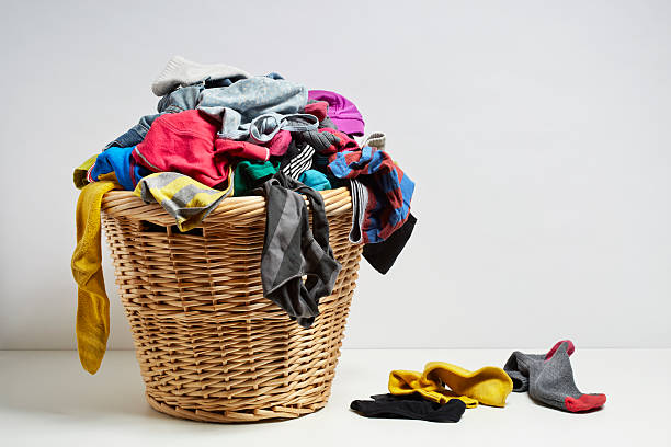 Overflowing laundry basket Overflowing laundry basket. Household chore concept on white background overflow stock pictures, royalty-free photos & images
