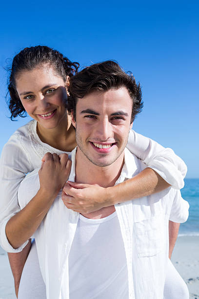 istock Handsome man giving piggy back to his girlfriend 481645534