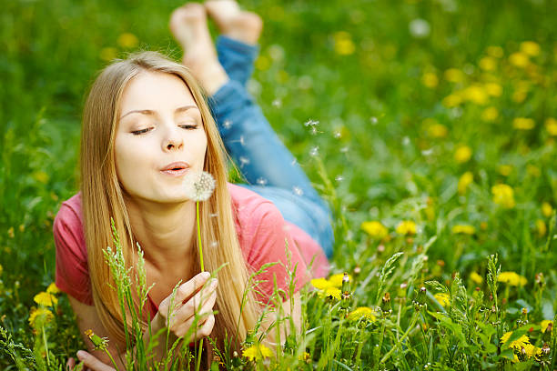 istock Girl blowing on a dandelion 481645831