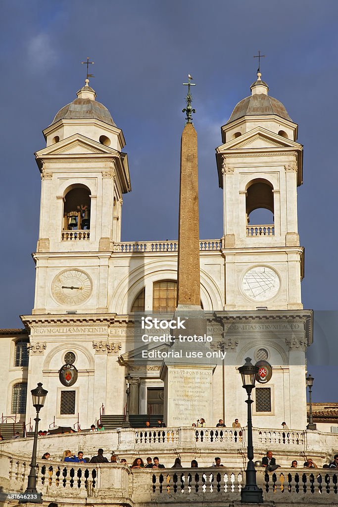 Church of Trinita dei Monti (Spanish Steps) in Rome, Italy Rome, Italy - November 14, 2012: Spanish Steps Tourists relax in the famous Spanish steps between the Piazza di Spagna at the base and Piazza Trinita dei Monti Ancient Stock Photo