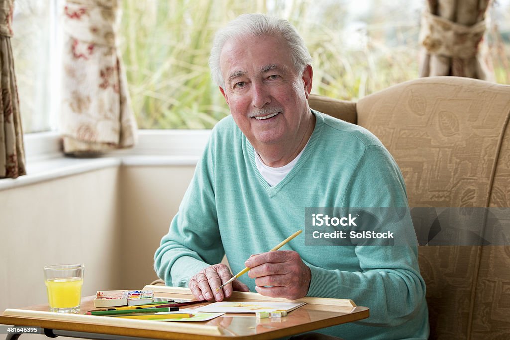 Senior Man Painting Happy senior man painting an image at home 70-79 Years Stock Photo
