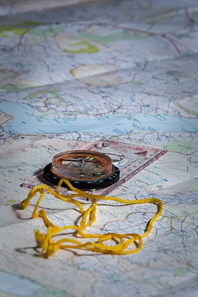 A photograph of a compass on a map.