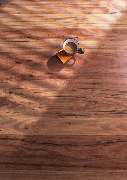 Cup of Coffee, Post-It Notes and Wooden Floor A cup of coffee perched on a coffee-ringed "Post-It" pad on a wooden floor. faux wood stock pictures, royalty-free photos & images