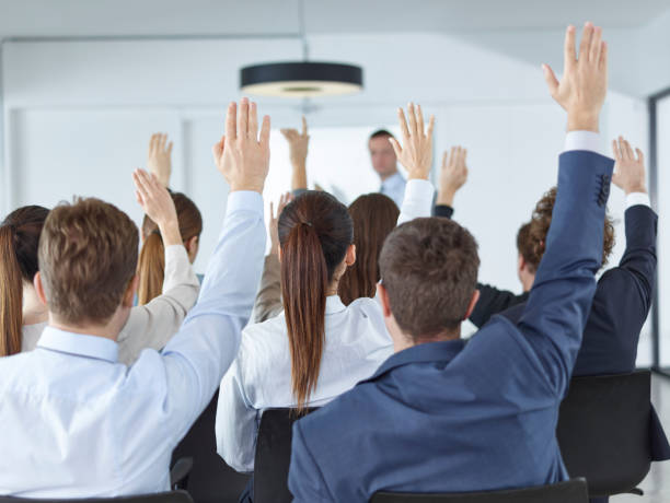 istock Business Spectators Or Students Raising Hands In Seminar 481651676