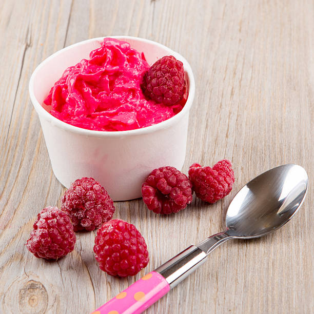 istock Frozen creamy ice yoghurt  with whole raspberries 481653546