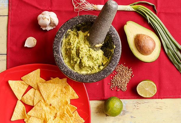 guacamole - mortar and pestle herb coriander seed cilantro foto e immagini stock