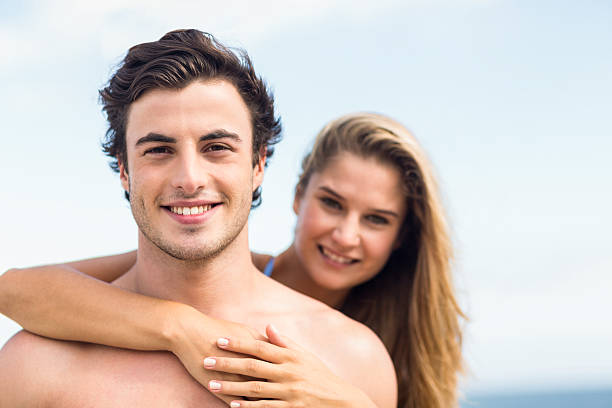 istock Happy couple in swimsuit looking at camera and embracing 481658852