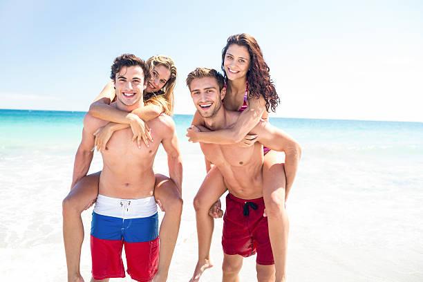 istock Handsome men giving piggy back to their girlfriends 481659772