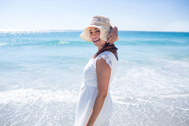istock Pretty brunette wearing straw hat and looking at camera 481663094