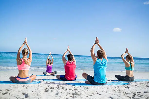 Photo of Friends doing yoga together with their teacher