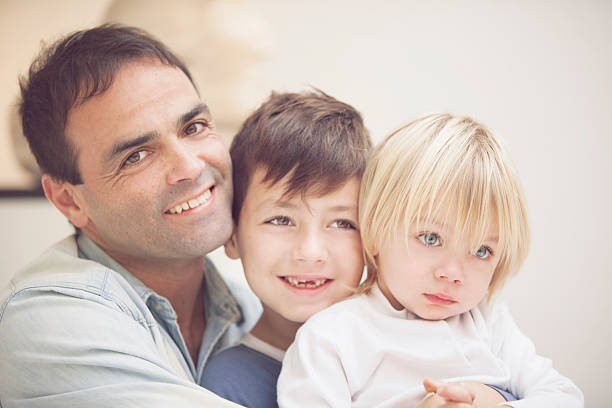 istock Happy father with offprings smiling 481664244