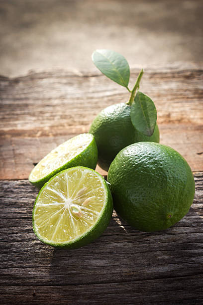 istock Fresh limes on wooden background. 481665792