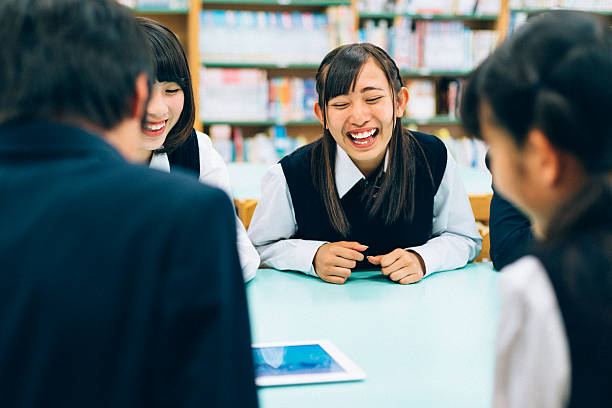 istock Japanese female students playing a fun digital tablet game 481665950