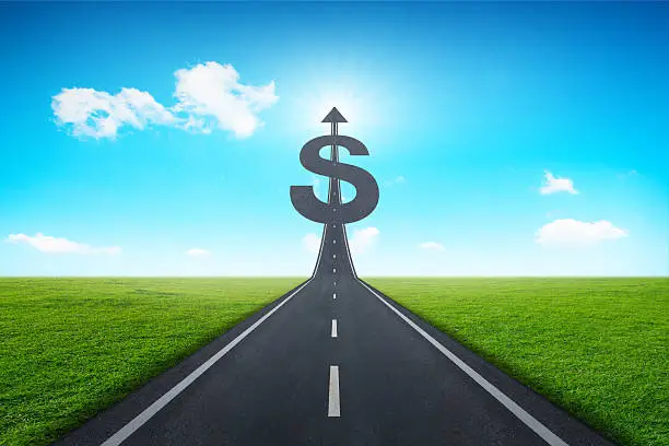 Photo of Road heading toward a dollar sign