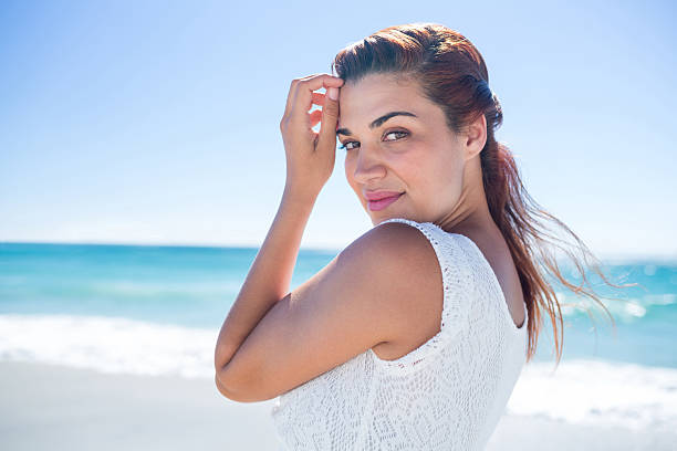 istock Pretty brunette relaxing beside the water 481666146