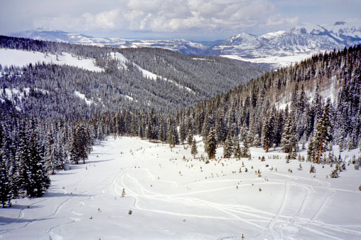 Photo of powder ski run from the top of Telluride Ski Resort mountain in Colorado.  This run can be accessed by a short hike from the ski lift that goes to the very top.  It is not groomed and holds powder.   Powder skiing skills are essential as it is not easy to ski otherwise.