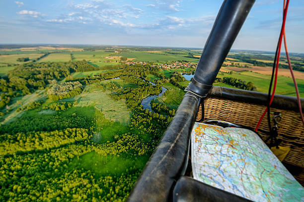 Hot air balloons fly over a corn field in Iowa.