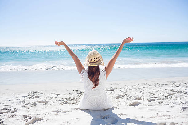 istock Brunette sitting in the sand 481670488
