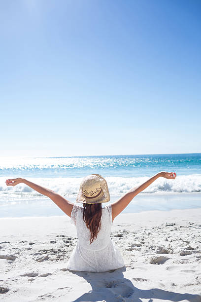 istock Brunette sitting in the sand 481670492