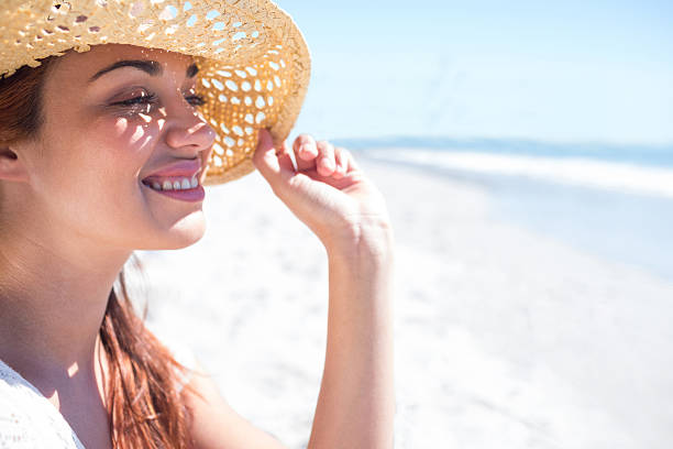 istock Brunette sitting in sand and looking at the sea 481670720