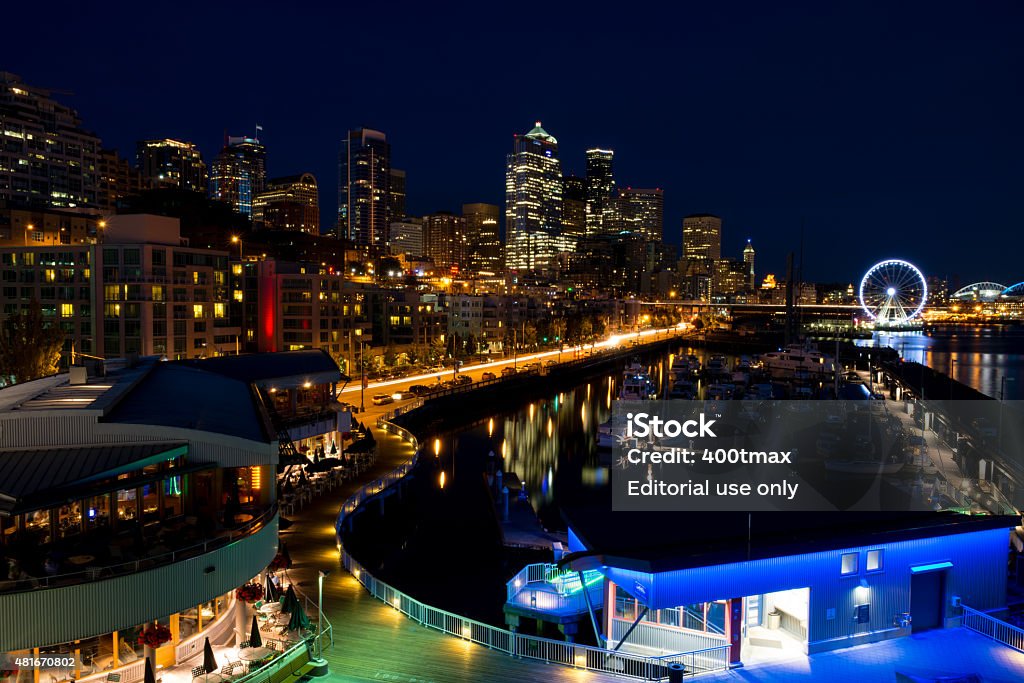 Seattle Waterfront New York, USA - July 16, 2015: The illuminated waterfront with the skyline at twilight. 2015 Stock Photo