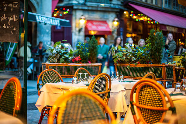 Outdoors Restaurant in Lyon, France Lyon, France - September 5, 2007: Outdoors Restaurant in Lyon, France. Empty tables waiting for clients. Unrecognizable people on the street. lyon photos stock pictures, royalty-free photos & images