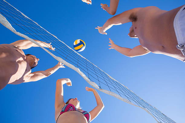 istock Group of friends playing volleyball 481671380