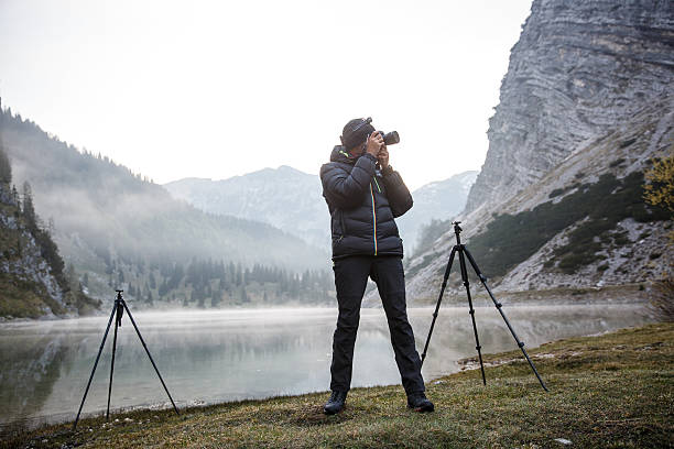 istock Photographer holding a camera, taking photos 481671748