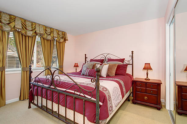 istock Cozy bedroom with red bedding and carpet. 481674886