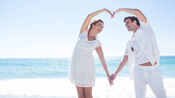 istock Happy couple forming heart shape with their hands 481675188
