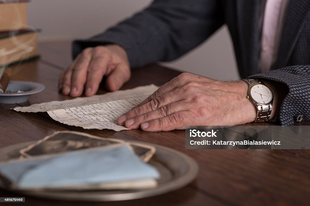 Male hands holding old letter Close-up of male hands holding old letter Letter - Document Stock Photo