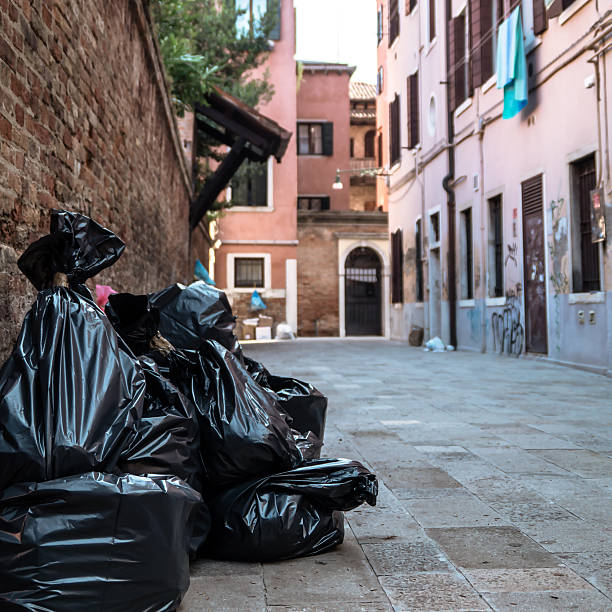 Garbage bags on the sidewalk.