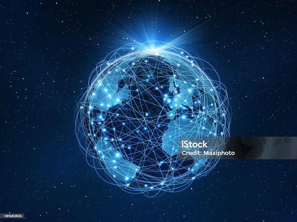 Planet Earth sourrounded by a global computer network Planet Earth surrounded by a complex computer network of glowing routes connecting nodes with bright lines: everything is connected in the Internet of Things. Global business. Planet floats in the blue outer space with a starfield and rising sun, with shining beams of light. Dark blue background. Copy space. Globe - Navigational Equipment Stock Photo