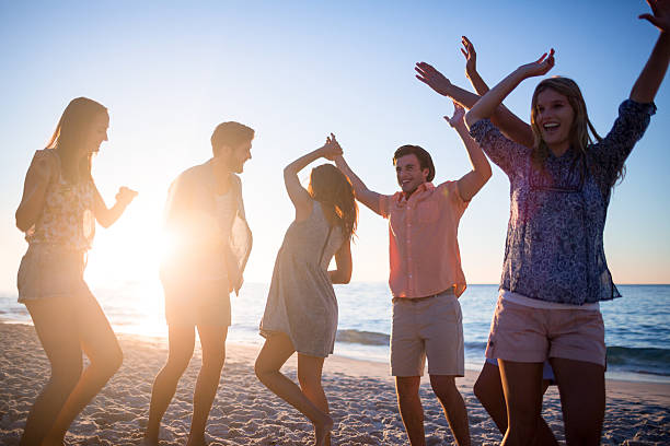 istock Happy friends dancing on the sand 481689174