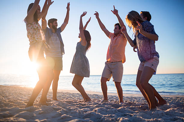 istock Happy friends dancing on the sand 481689178