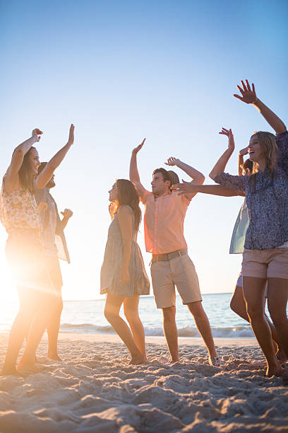 istock Happy friends dancing on the sand 481689184