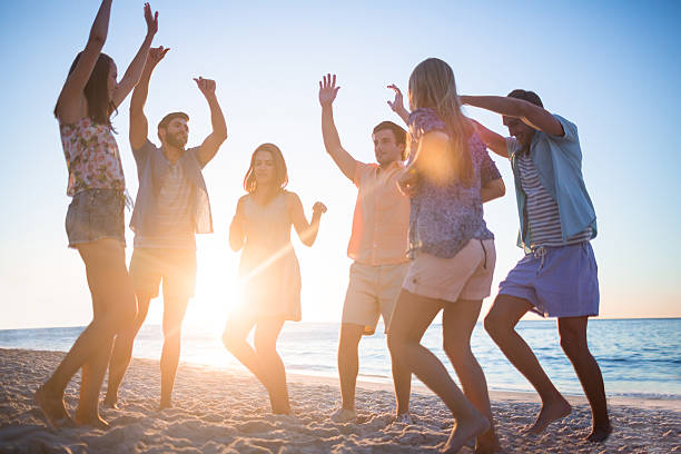 istock Happy friends dancing on the sand 481689186